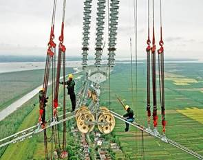 Chinese workers building a UHV line across the Yangtze River.
